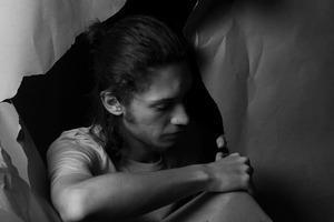 A young man looking disappointed in himself symbolizing self sabotage