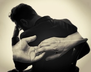 Man in despair fused with grasping hands, a symbol of emotional attachment